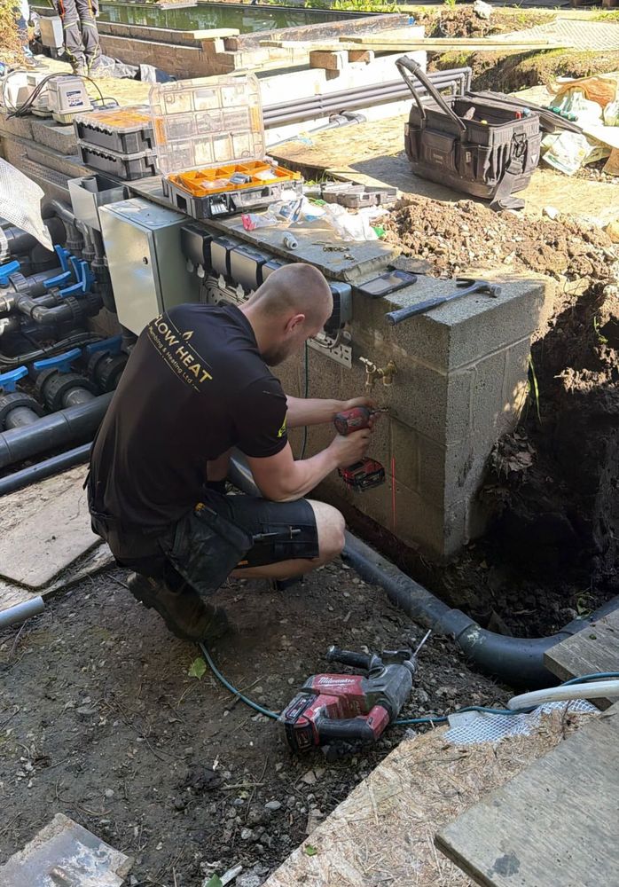 A Flow Heat engineer on a job, fitting pipework on site