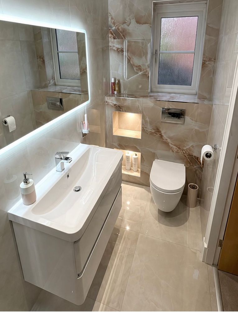 Marble-effect tiled bathroom with wall-hung vanity and recessed lighting